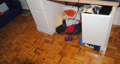 Children storing their clothes in a broken desk